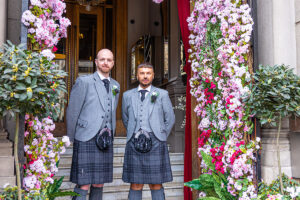 two grooms standing outside the Corinthian Club in Glasgow