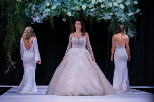 Three models on the catwalk at the Scottish Wedding Show wearing dresses from Kathleen Richmond Couture