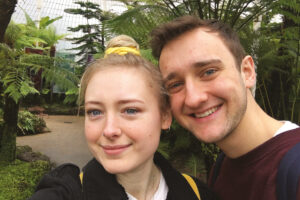 two people taking a selfie in a glasshouse