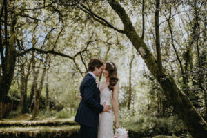 bride and groom kissing woods, outdoors,