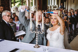 a bride and a groom light a trio of candles at a wedding ceremony led by a Fuze Ceremonies celebrant