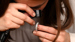 Customer examine diamonds in a diamond wedding band