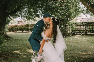bride and groom kissing under a tree at Garfield House Hotel