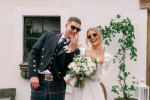 a bride and groom wearing sunglasses smiling outside Fruin Farm