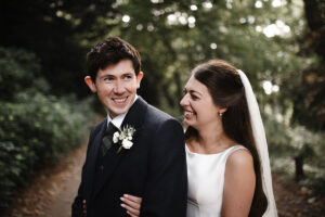a smiling bride and groom in the grounds of balbirnie house