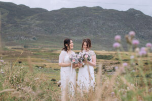 two brides standing in front of mountains in the Cairngorms National Park