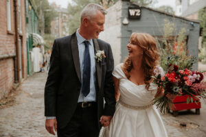 a bride and groom walking on Ruthven Lane in Glasgow