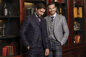 Two male models wearing checked tweed suits