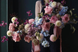 a pink, blue and purple loosely arranged bridal bouquet by Wild Flower Workshop