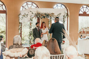 a bride and groom standing under a chuppah during a wedding ceremony performed by Independent Humanist Ceremonies