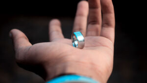 Guy holding his engraved wedding band
