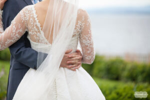 Bride and groom kiss in the garden before their Shelburne Farms VT wedding.