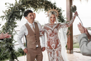 a cheering bride and groom at Mhares Beach Club in Mallorca