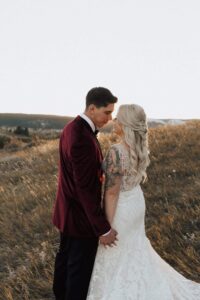 bride and groom smiling at each other